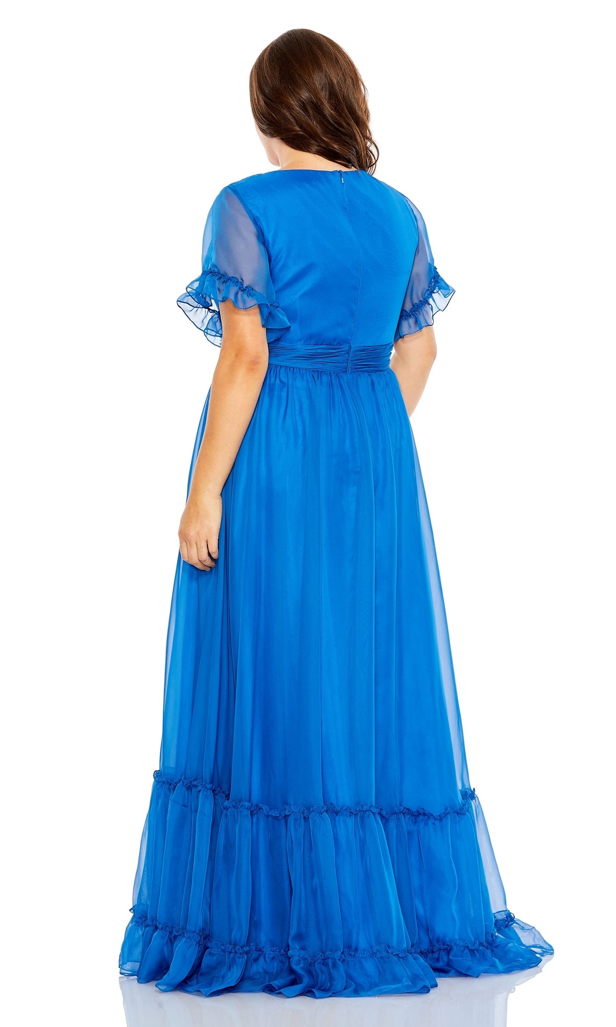 A woman faces away, showcasing the back of the Long Plus-Size Formal Dress 68430 by Mac Duggal in bright blue—a short-sleeve, ruffled a-line gown—against a white background.